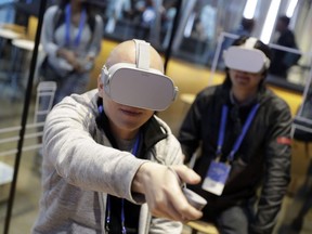Attendees try the new Oculus Go goggles during F8, Facebook's developer conference in San Jose, Calif., May 1, 2018.