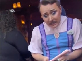 Man named Nick working at Disney wearing a fairy godmother's apprentice costume.