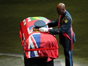 The hat of OPP Sgt. Eric Mueller is placed on his casket during his funeral service in Ottawa on Thursday, May 18, 2023. Sgt. Mueller was killed last week while responding to a call with two other officers in Bourget, Ont.