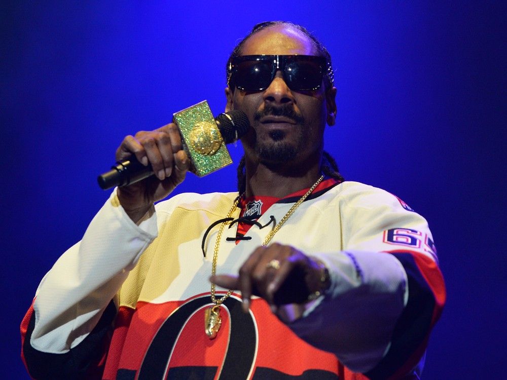 Rapper Snoop Dogg attends an NHL hockey game between Los Angeles