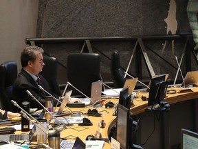 Former city councillor Rick Chiarelli sits alone in council chambers in 2019. Other councillors shunned Chiarelli and voted to suspend him, but did not have the power to remove him from office after he was found to have bullied and harassed staff.