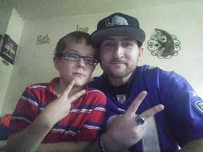 Chris Wright, right, and eldest son giving peace signs.
