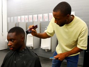 Malcolm Shaw cuts the hair of his teammate Aboubakary Sacko.