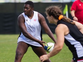 Canada;s Alex Ellis looks for a pass during rugby training.