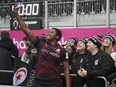 Canadian rugby player Alex Ellis takes a selfie with fans.