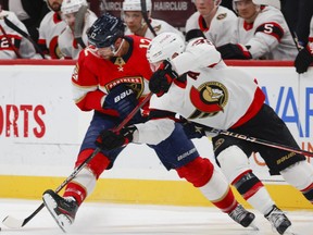 Florida Panthers' Eric Staal and Ottawa Senators' Claude Giroux vie for the puck.