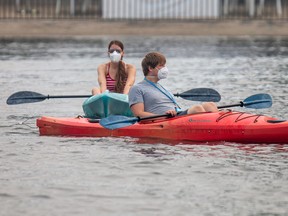 Paddlers were wearing masks on the Rideau River at Mooney’s Bay, as Ottawa was dealing with bad air quality with smoke in the air Sunday, June 25, 2023.
