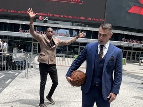Toronto Raptors president Masai Ujiri photobombs head coach Darko Rajakovic outside the ScotiaBank Arena during a photo-op on Tuesday.