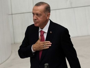Turkish President Tayyip Erdogan greets members of the parliament and guests as he arrives to take oath of office after his election win at the parliament in Ankara, Turkey, on June 3, 2023. Turkey's Recep Tayyip Erdogan was sworn in for a third term as president on June 3, promising to serve "impartially" after winning a historic runoff election to extend his two-decade rule. (Photo by Adem ALTAN / AFP)