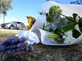 Flowers are left by the road some 500 meters from the site of a bus crash, where 10 people from a wedding party were killed, in Cessnock, in Australia's Hunter wine region north of Sydney on June 12, 2023.