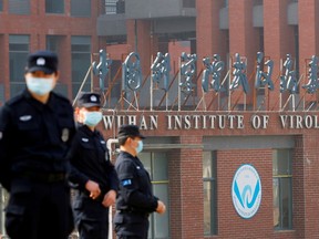 Security personnel keep watch outside the Wuhan Institute of Virology during the visit by the World Health Organization team tasked with investigating the origins of the coronavirus disease in Wuhan, China Feb. 3, 2021.