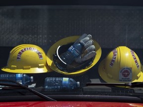 Firefighters' helmets and water bottles rest against the windshield of a truck at a command centre within the evacuated zone of the wildfire burning in Tantallon, N.S., outside of Halifax on Wednesday, May 31, 2023. Scattered showers are moving across parts of Nova Scotia this morning, providing some relief to a province still struggling with its worst wildfire season on record.