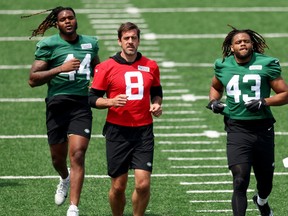 Aaron Rodgers (centre) warms up with New York Jets teammates at practice.