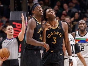 Raptors' Pascal Siakam (left) and O.G. Anunoby watch a replay of Anuoby's dunk.