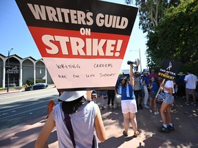 Hollywood actors, writers and their supporters walk the picket line