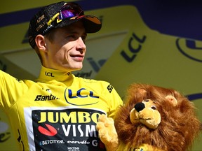Jumbo-Visma's Danish rider Jonas Vingegaard celebrates on the podium with the overall leader's yellow jersey after the 17th stage of the 110th edition of the Tour de France cycling race, 166 km between Saint-Gervais Mont-Blanc and Courchevel, in the French Alps, on July 19, 2023.