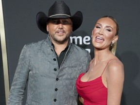 Jason Aldean, left, and Brittany Kerr arrive at the 58th annual Academy of Country Music Awards on Thursday, May 11, 2023, at the Ford Center in Frisco, Texas. (AP Photo/Jeffrey McWhorter)