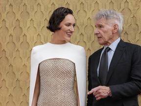 Phoebe Waller-Bridge and Harrison Ford pose for photographers upon arrival at the premiere of the film 'Indiana Jones and the Dial of Destiny' on Monday, June 26, 2023 in London.