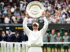 Marketa Vondrousova of Czech Republic lifts the Women's Singles Trophy following her victory in the Women's Singles Final against Ons Jabeur of Tunisia on day 13 of The Championships Wimbledon 2023 at All England Lawn Tennis and Croquet Club on July 15, 2023 in London.