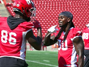 Calgary Stampeders wide receiver Marken Michel gestures to teammate Tre Odoms-Dukes during practice at McMahon Stadium. Friday, July 21, 2023.