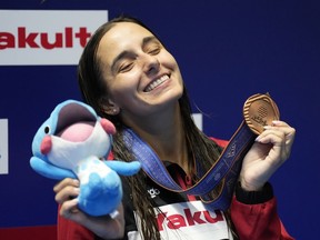 Pamela Ware of Canada celebrates with her bronze medal after the women's 3m springboard diving final at the World Swimming Championships in Fukuoka, Japan, Friday, July 21, 2023.