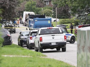 Investigators continue work in Kanata on Tuesday afternoon at the scene of a fatal collision involving a dump truck.