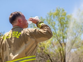 A firefighter takes a water break