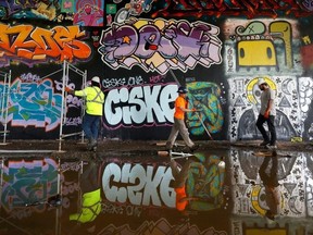 Damian Hermosa, Masa Lauriault and Jacques Jr. Groulx from Scaffex tear down some scaffolding Tuesday. The crew were tearing down equipment set up for the House of PainT Festival, held over the weekend at various locations in the city after flooding forced it from its main spot.