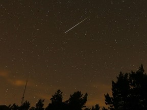 FILE - In this long exposure photo, a streak appears in the sky during the annual Perseid meteor shower at the Guadarrama mountains, near Madrid, in the early hours of Aug. 12, 2016. The best viewing for the annual shower visible around the world will be from Saturday night, Aug. 12, 2023, local time, into early Sunday morning, when viewers might be able to spot a meteor per minute.