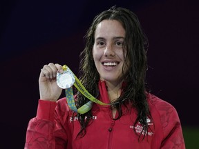 Canada's silver medalist Aurelie Rivard celebrates during a medal ceremony for the Women's 200m Individual Medley SM10 Final of the swimming competition at the Commonwealth Games, at the Sandwell Aquatics Centre in Birmingham, England, Tuesday, Aug. 2, 2022.