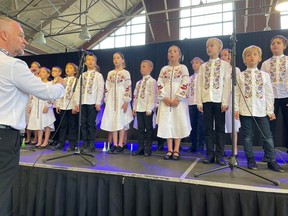 Oleksii Fishchuk, far left, leads the Ottawa Ukrainian Children's Choir of newcomers to Ottawa at the Capital Ukrainian Festival on Saturday.