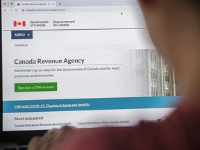 A person looks at a Canada Revenue Agency homepage