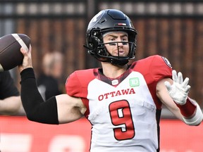 Ottawa Redblacks quarterback Nick Arbuckle throws a pass during first half CFL football action against the Montreal Alouettes in June.