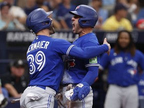 Blue Jays' George Springer, right, celebrates with the Jays' Kevin Kiermaier