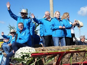 Ontario Premier Doug Ford rides with supporters on a float towed by a tractor at the 2023 International Plowing Match and Rural Expo, in Bowling Green, Ont., Tuesday, Sept. 19, 2023.