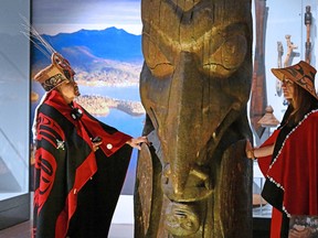 Amy Parent, right, is shown with the Ni'isjoohl memorial pole alongside Nisga'a Chief Earl Stephens during a visit to the National Museum of Scotland in this handout image provided by National Museums Scotland. Parent says the pole is set to begin its month-long journey home to the Nisga'a Nation in northwestern British Columbia.