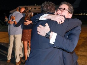 Family members embrace freed US Siamak Namazi (R), after disembarking from an airplane at Davison Army Airfield at Fort Belvoir, Virginia, on September 19, 2023.