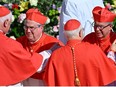 Newly elevated cardinals, archbishop from Cordoba Angel Sixto Rossi (L) and archbishop from Bogota in Colombia Luis Jose Rueda Aparicio (R) are congratulated by fellow cardinals at the end of a consistory to create 21 new cardinals at St. Peter's square in The Vatican on September 30, 2023.