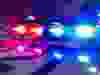 Police car lights in night time, crime scene, night patrolling the city. Abstract blurry image.