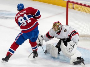 Ottawa Senators goaltender Joonas Korpisalo makes a save on the Montreal Canadiens' Sean Monahan during second period NHL preseason action in Montreal on Wednesday, Sept. 27, 2023.