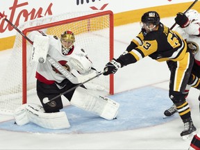 Ottawa Senators goaltender Joonas Korpisalo makes a save in front of Pittsburgh Penguins' Radim Zohorna.