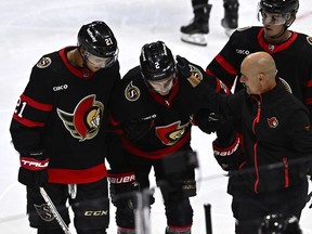 Ottawa Senators defenceman Artem Zub is helped off the ice after getting hit by the puck off a shot by Washington Capitals' Alex Ovechkin.