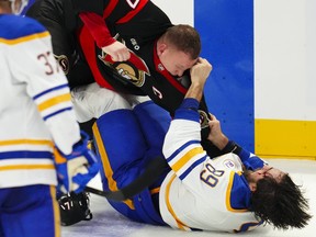 Ottawa Senators' Brady Tkachuk (top) and Buffalo Sabres winger Alex Tuch (89) fight during Tuesday's game.