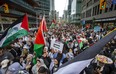 Pro-Palestinian march makes its way north along Bay St. in downtown Toronto on Monday, Oct. 9, 2023.