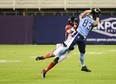 Toronto Argonauts wide receiver David Ungerer III receives a pass from quarterback Chad Kelly, while Ottawa Redblacks defensive back Alijah McGhee attempts to intercept in Toronto last night. For more, visit ottawasun.com.  Christopher Katsarov/THE CANADIAN PRESS