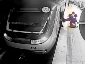 In this image from surveillance video aired by Iranian state television, women pull 16-year-old Armita Geravand from a train car on the Tehran Metro in Tehran, Iran, Sunday, Oct. 1, 2023.
