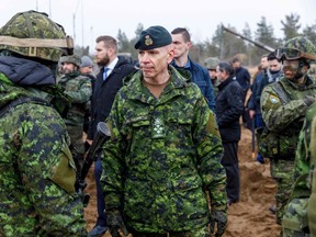 General Wayne Donald Eyre (C), Canadian chief of the Defence Staff (CDS) talks with soldiers during a visit of the Adazi military base, north east of Riga, Latvia, on March 8, 2022.