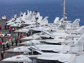This handout picture courtesy of the U.S. Navy released on Oct. 15, 2203 shows F/A-18 Super Hornets, attached Carrier Air Wing (CVW) 8, preparing for flight operations on the flight deck of the world's largest aircraft carrier, USS Gerald R. Ford (CVN) 78, in the Eastern Mediterranean Sea, Oct. 13, 2023.