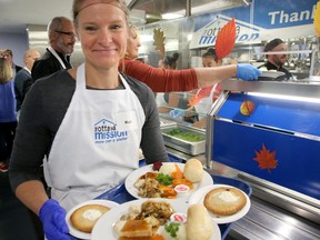 Volunteer serving meals at Ottawa Mission