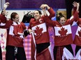 Canadian players including captain Caroline Ouellette celebrate after beating the United States 3-2